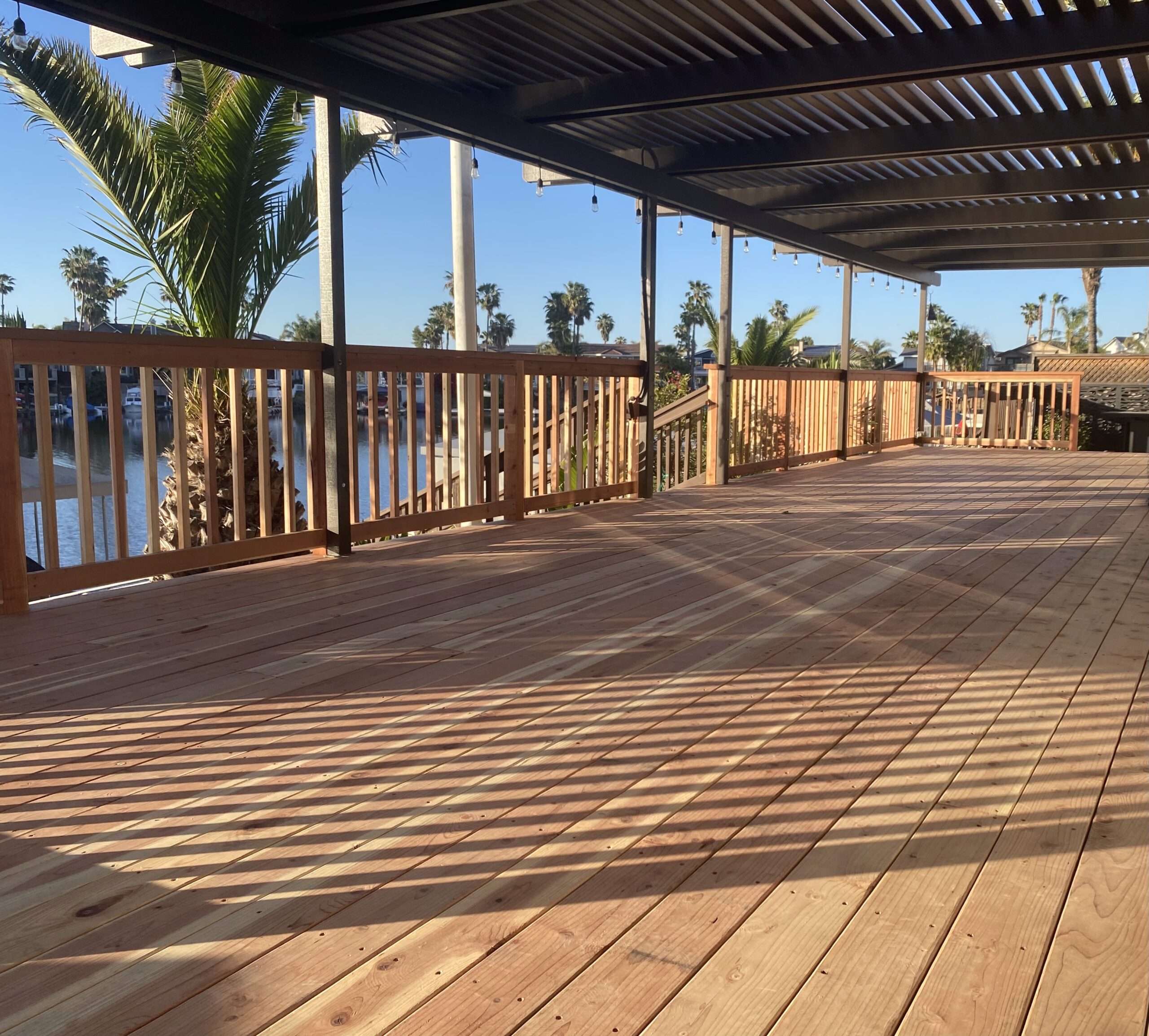 hard-wood-long-residential-deck-with-railings-on-the-pergola-with-lighting-featuring-overlooking-view-in-manteca-and-central-valley-ca