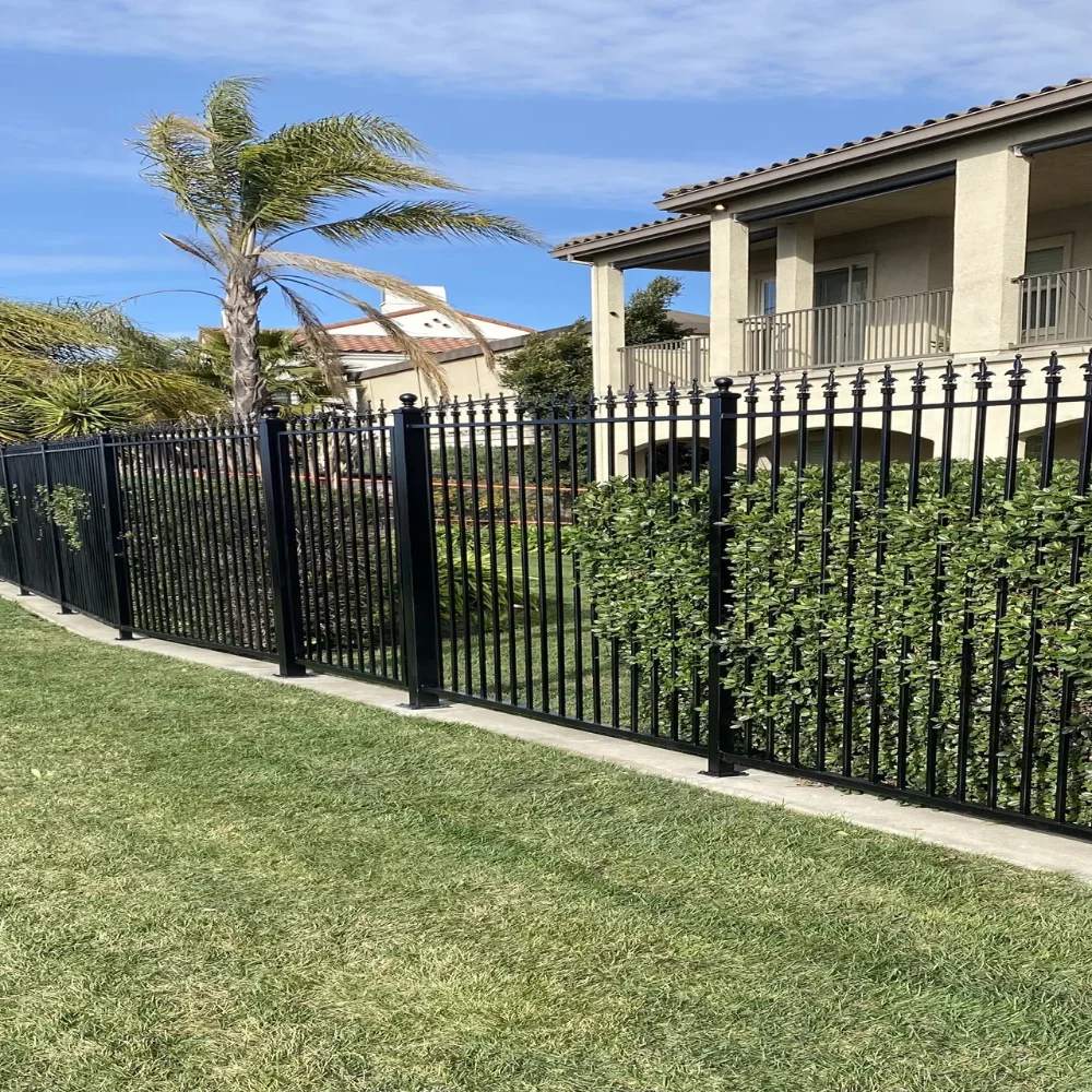 ornamental-black-metal-fence-installation-surrounded-by-grass-and-trees-in-manteca-ca
